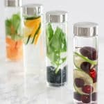 Infused water recipes in 4 glass bottles.