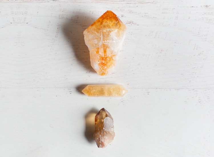 citrine healing crystal on a white background with other orange crystals